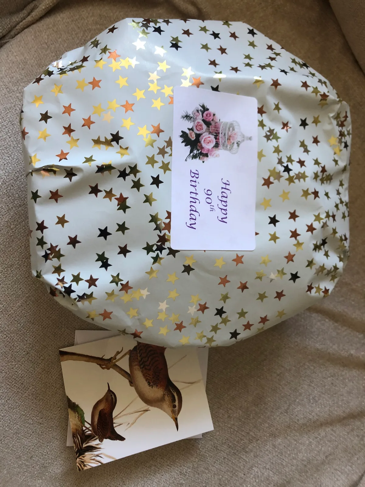 A gift-wrapped Tregunter basket finished in gold-star paper with a 'Happy 90th Birthday' label and a greetings card.